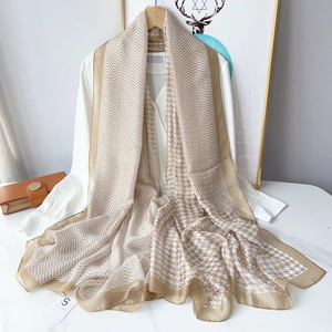 Detail of chevron and houndstooth texture on beige lightweight summer scarf wrap