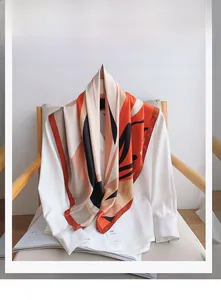 Detail view of abstract print 100% polyester silk scarf on white shirt