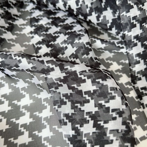 Detailed view of lightweight houndstooth scarf showing silky texture and elegant draping