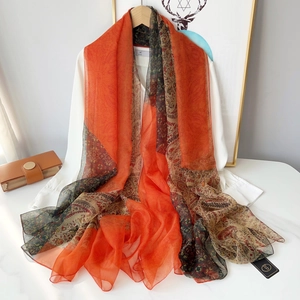 Lightweight paisley printed beach shawl in bright orange and green colors for summer wear