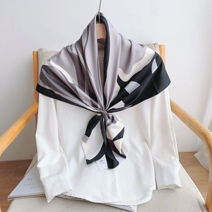 Elegant black and white geometric silk scarf for women styled with a chic metallic buckle