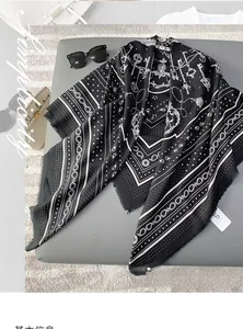 Detail of elegant black and white silk shawl with vintage key and star patterns