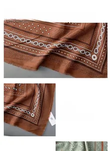 Detail of the brown paisley print scarf with decorative frayed edge design and tassels