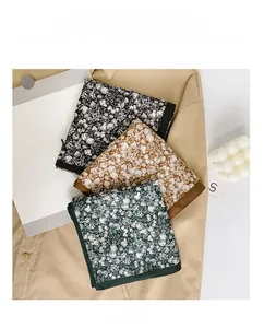 Detailed view of vintage floral cotton scarves in black, brown, and green for women
