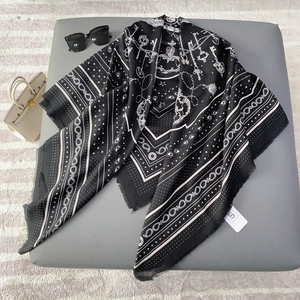 Elegant black silk shawl with white vintage crest print and delicate fringe details