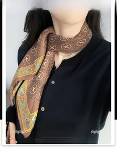 Detailed view of brown cotton-linen scarf with vintage geometric patterns tied around the neck