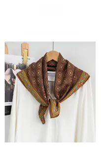 Detailed view of a brown cotton-linen square scarf with orange and blue geometric patterns