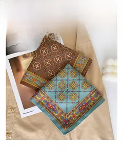 Detail of retro geometric print silk scarves in brown and blue colors on a shirt