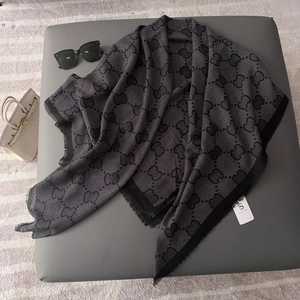 Classic black and white monogram jacquard scarf with frayed edges and tassel finish