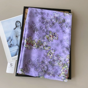 Close-up of floral lilac chiffon scarf with vintage print and SIYA Scarf brand tag