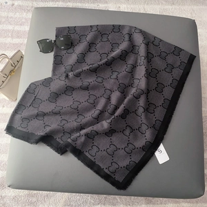 Classic black and white monogram scarf with fringed edges and elegant letter pattern
