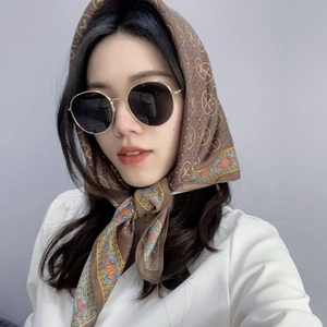 Close-up of vintage printed cotton linen scarf and golden round sunglasses set on model