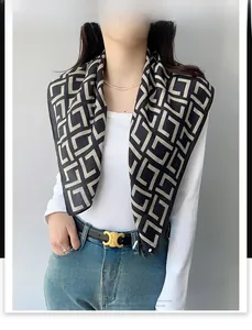 Detailed view of fashion square scarf with black and white geometric maze pattern print