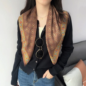 Detail of brown cotton linen square scarf with geometric pattern and bohemian border