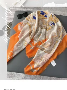 Detailed pattern of orange silk square scarf with horse bridle and tassel print design