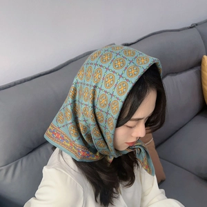 Bohemian printed square headscarf with geometric pattern worn as a stylish neck shawl