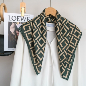 Close-up of geometric pattern silk scarf draped on a shirt for a luxury styling look