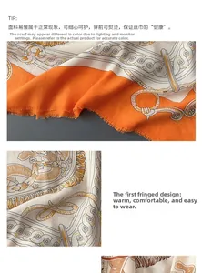 Detail of baroque print silk scarf featuring frayed edge design in orange and grey