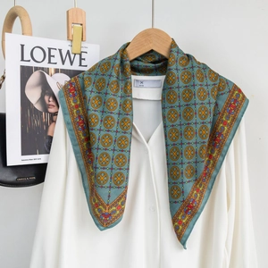 Detail of blue cotton-linen neck scarf with geometric print on white shirt collar