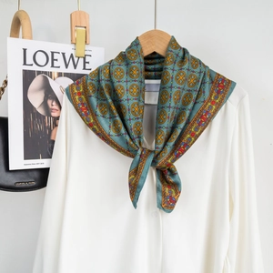 Retro pattern silk scarf in lake blue and orange, styled with a white shirt