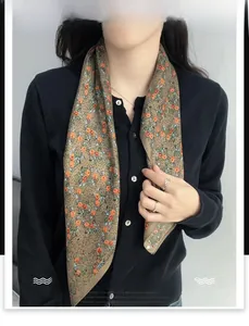 Detailed macro view of the floral patterned silk scarf with herringbone weave texture