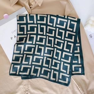 Elegant dark green cotton-linen scarf with geometric pattern over a stylish khaki shirt