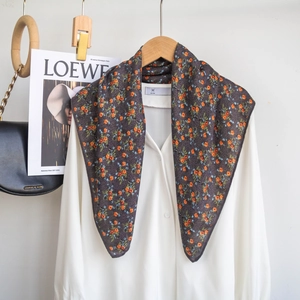 Floral silk scarf with orange and blue blossom pattern styled with a white shirt