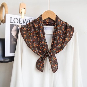 Floral silk scarf tied on a white shirt collar with vintage brown and orange patterns