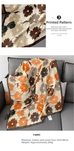 Detail of floral linen scarf showing vintage daisy pattern and high-quality fabric texture