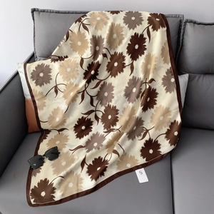 Detailed close-up of soft floral cotton linen scarf with daisy print and fine edge stitching