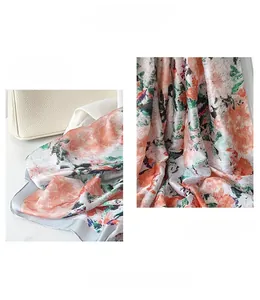 Detail showing the elegant floral print scarf and refined edge processing of the fabric