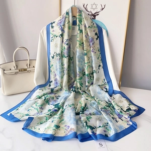 Elegant silk-like scarf with blue watercolor floral prints and navy blue border