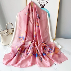 Close-up of lightweight floral chiffon scarf with realistic leaf print in soft pink tones