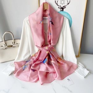 Close-up of elegant floral chiffon scarf tied on shirt with silk satin texture