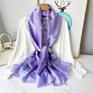Detail of elegant purple floral chiffon scarf with smooth satin texture and leaf print
