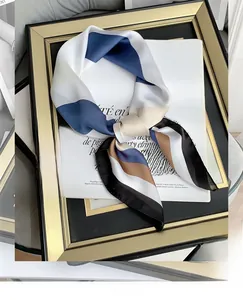 Detail of silk-like square scarf featuring navy blue and beige striped texture