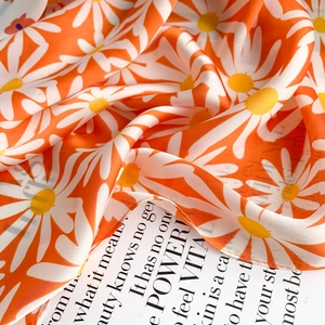 Floral square scarf with vibrant orange daisy print on smooth faux silk fabric