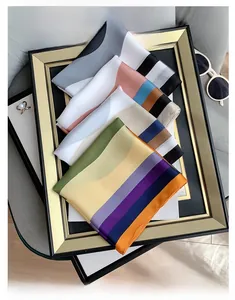 Detailed view of colorful geometric silk scarves stacked on a decorative frame with accessories