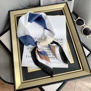 Silk-like striped square scarf in navy, white, and brown on a fashion magazine background