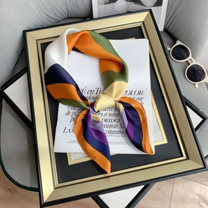 Detailed view of striped faux silk scarf with satin finish and golden frame decor