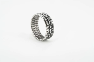 Macro shot of silver punk ring featuring detailed dragon scale and crocodile skin textures