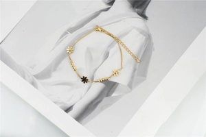 Detailed close-up of golden daisy flower box chain with adjustable lobster clasp