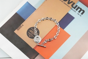 Detail of silver titanium steel chain bracelet with OT toggle clasp and round pendant