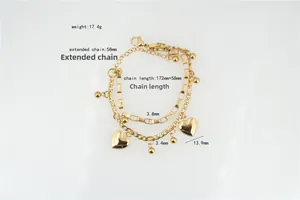Detail showing double-layered gold steel chain bracelet with heart charms and lobster clasp