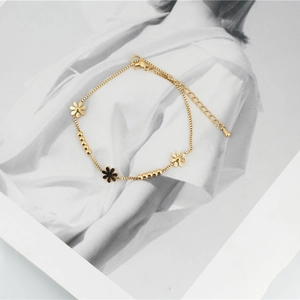 Golden daisy flower bracelet made of titanium steel with black enamel and hollow charms