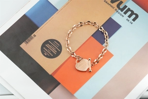Rose gold heart pendant bracelet with engraved quote and toggle clasp detail