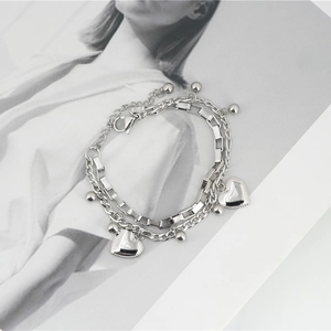 Double-layered silver steel heart pendant bracelet with geometric chains and adjustable clasp