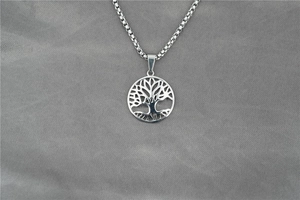 Detailed close-up of hollow Tree of Life circular pendant with square box chain link