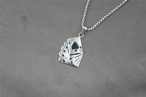 Macro view of steel pendant showing five fan-shaped poker cards with Ace of Spades detail