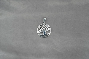 Detail view of a polished stainless steel tree of life pendant with hollowed design